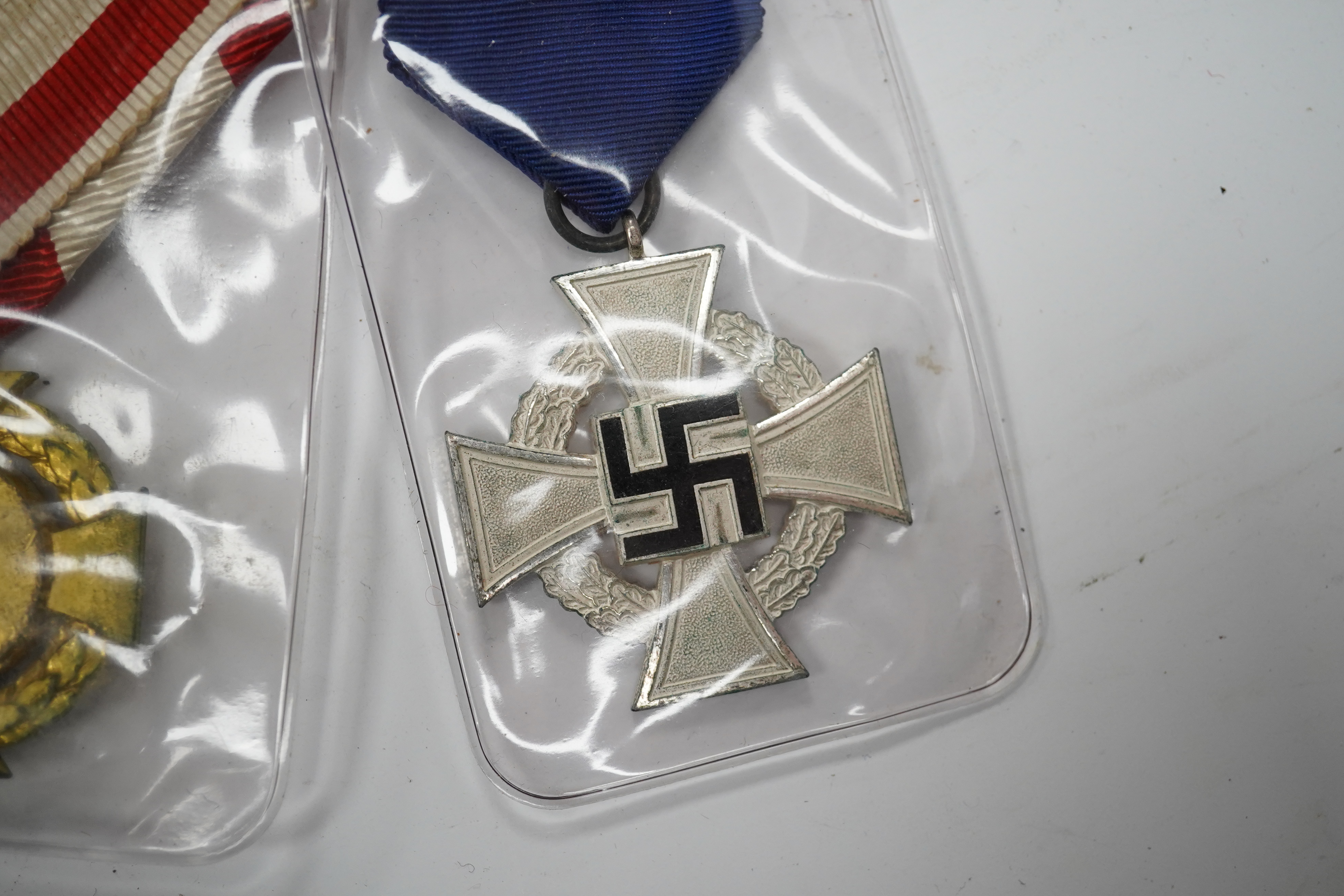 Fifteen British, German, etc. military medals including; a First World War medal pair to DVR. A.E. Hooker. R.A., a boxed WWII Defence Medal, a 1914 Second Class Iron Cross, a France Italian Campaign medal, a 1939 German